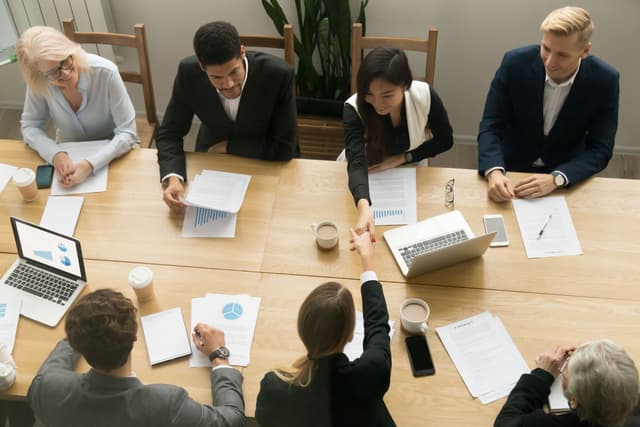 Business meeting with people discussing at a table