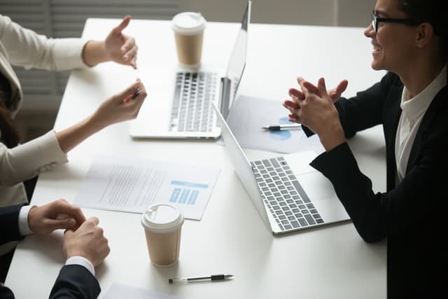 People shaking hands over a business deal